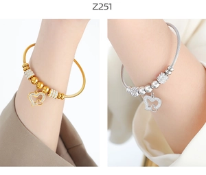 Close-up of geometric heart pendant bracelets with zircon in gold and silver finish