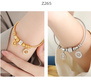 Macro view of gold and silver steel wire bracelets with zircon encrusted number 8 charms