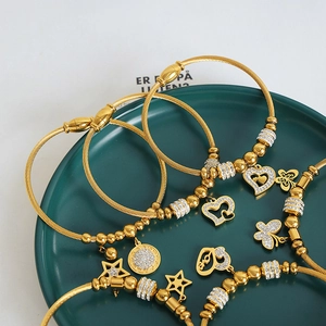 Gold-plated steel cable bracelet set with heart, star, and butterfly zircon charms