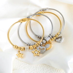 Stack of gold and silver steel wire rope bracelets with zircon star and heart charms