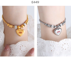 Detail of heart evil eye charm bracelets with pave zircon on gold and silver beaded chains