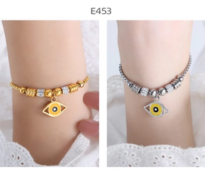 Detail of gold and silver American hip-hop style evil eye bracelets with crystal accents