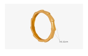 Detail view of the 0.32cm wide gold bamboo joint ring in polished titanium steel
