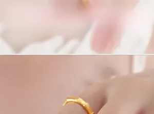 Detailed view of a bamboo-style gold plated ring worn elegantly on a woman's finger