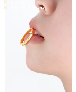 Macro shot of a gold bamboo-style ring with detailed joints on a high-fashion background