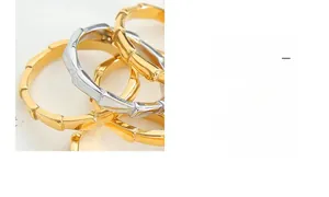 Macro shot of polished gold and silver bamboo style rings showing textured metal detail