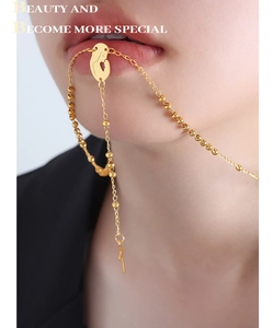 Detail of 18K gold-plated long fringe necklace with geometric pendant and bead accents