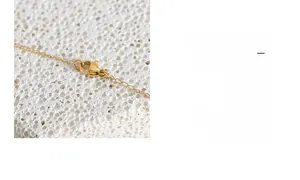 Macro shot of polished gold necklace chain featuring a durable lobster clasp closure