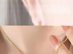 Detail of 18K gold plated stainless steel O-chain necklace worn on model neck