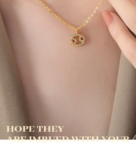 Macro shot of Cancer zodiac sign pendant with sparkling rhinestones on gold chain