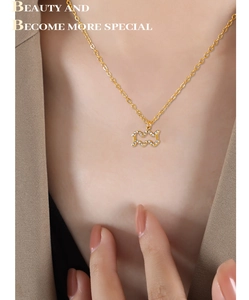 Detail of 18K gold plated Aquarius zodiac pendant with sparkling rhinestones on neck