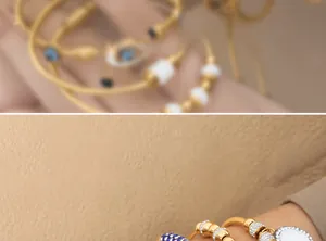 Detail of gold beaded bracelet with blue enamel accents and pavé crystal charms