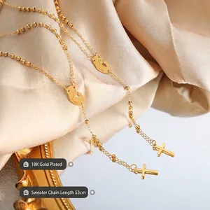 18K gold plated necklace with cross and silhouette pendants on champagne silk
