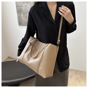 Detail of adjustable strap and metal buckle on large khaki minimalist tote bag