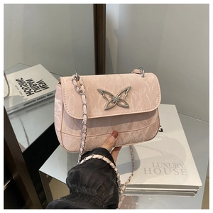 Detail of light pink wrinkled texture bag featuring a silver butterfly metallic buckle