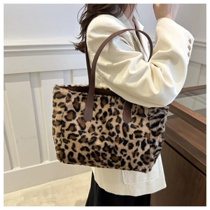 Detail of plush leopard print tote bag with soft faux fur texture and leather strap
