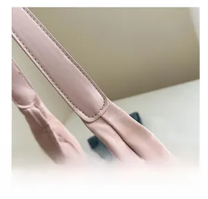 Detailed view of reinforced stitching and textured PU leather on pink tote bag shoulder strap