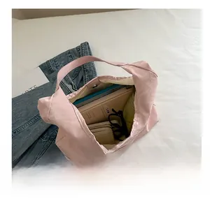 Pink pleated tote bag interior showing large capacity for tablet and daily items