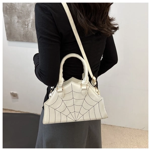 Detailed view of white spider web embroidery on a PU leather crossbody handbag for women