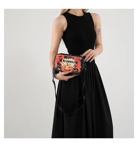 Black Halloween crossbody bag featuring orange pumpkin and bat prints worn by a model