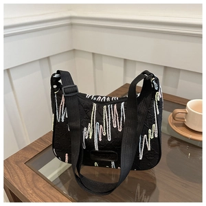 Detail of black nylon bag with colorful wave embroidery and adjustable wide strap