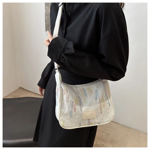 Detail of white nylon crossbody bag with colorful drip embroidery and adjustable strap
