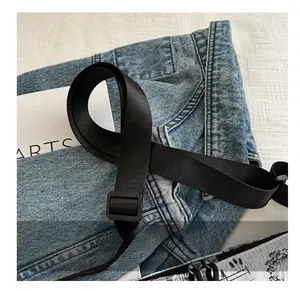 Macro shot of adjustable black nylon strap with buckle for the shoulder bag