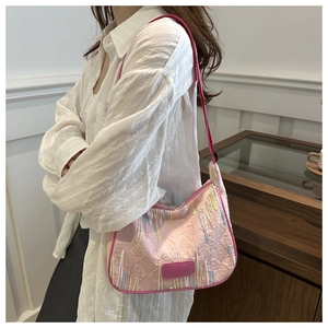 Detail of pink nylon hobo bag featuring luxury Zucca monogram and colorful bead fringes