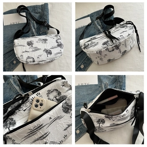 Detail view of half-moon crossbody bag with ink landscape print and pleated texture