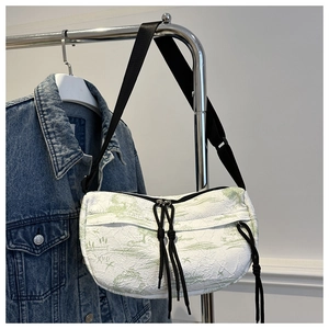 Detail of white nylon crossbody bag featuring green ink painting and black drawstring