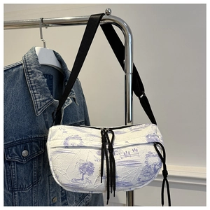 Detail of crescent crossbody bag with purple landscape print and crinkled texture