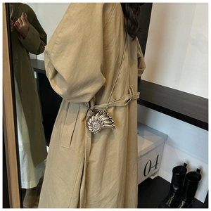 Detailed view of silver nautilus-shaped metal mini bag with sleek chain strap