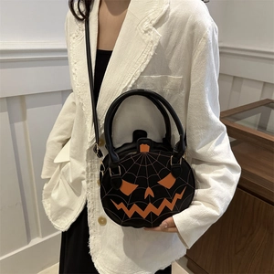 Quirky pumpkin-shaped handbag with orange face and spiderweb stitching details