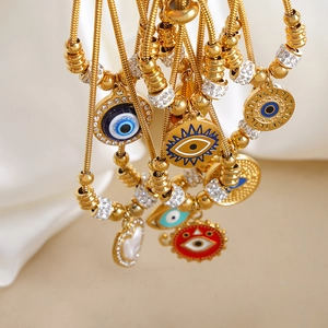 Lujosas pulseras doradas de ojo turco con esmalte colorido y cristales brillantes