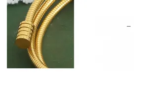 Détail macro d'un bracelet chaîne serpent dorée avec finition texturée et fermoir cylindrique