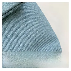 Close-up of premium light blue denim fabric texture on a star pattern shoulder bag