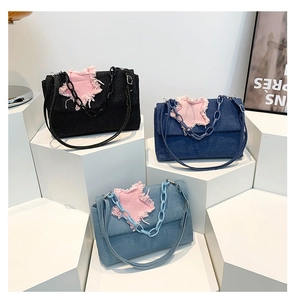 Three denim bags with frayed pink star patches and chunky chains in high-quality texture
