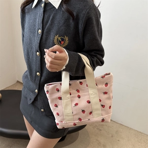 Pink corduroy strawberry tote bag with white canvas handles for women in daily use