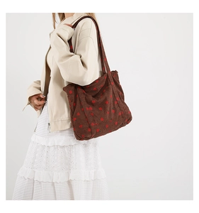 Detail view of brown corduroy tote bag with strawberry embroidery and large capacity