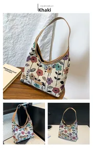 Detail of vintage floral jacquard tote bag with khaki leather straps and fashion label