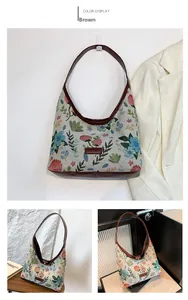 Detailed view of floral tapestry handbag with brown leather trim and fashion label