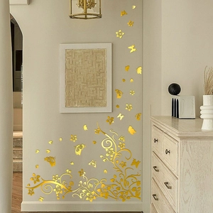 Golden mirror wall stickers featuring wisteria vines and butterflies in a modern living room