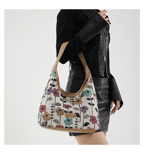 Close-up of bohemian jacquard fabric shoulder bag with floral embroidery and leather trim