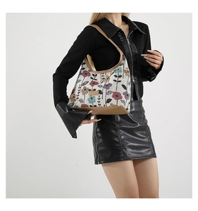 Close-up of floral jacquard fabric and premium brown faux leather trim on the tote bag