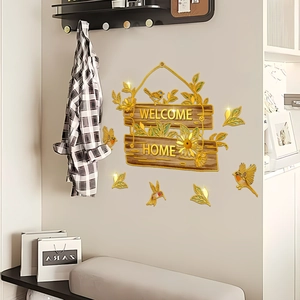 Detail van 3D-muurstickers Welcome Home met gouden letters en rustieke zonnebloemen