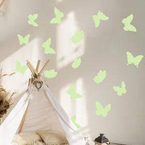 Close-up of luminous butterfly wall stickers glowing on a cozy bedroom tent wall