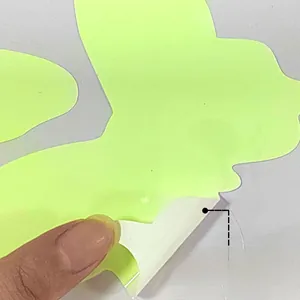 Glow in the dark butterfly wall decal being peeled to show adhesive backing