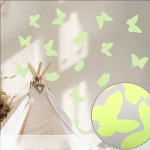 Detailed view of luminous butterfly wall stickers glowing on white fabric background