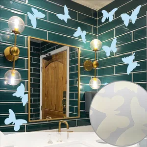 Detailed view of luminous butterfly wall stickers glowing on dark bathroom tiles