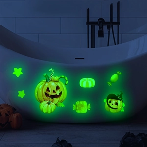 Luminous Halloween pumpkin and candy wall stickers glowing green in a dark bathroom setting